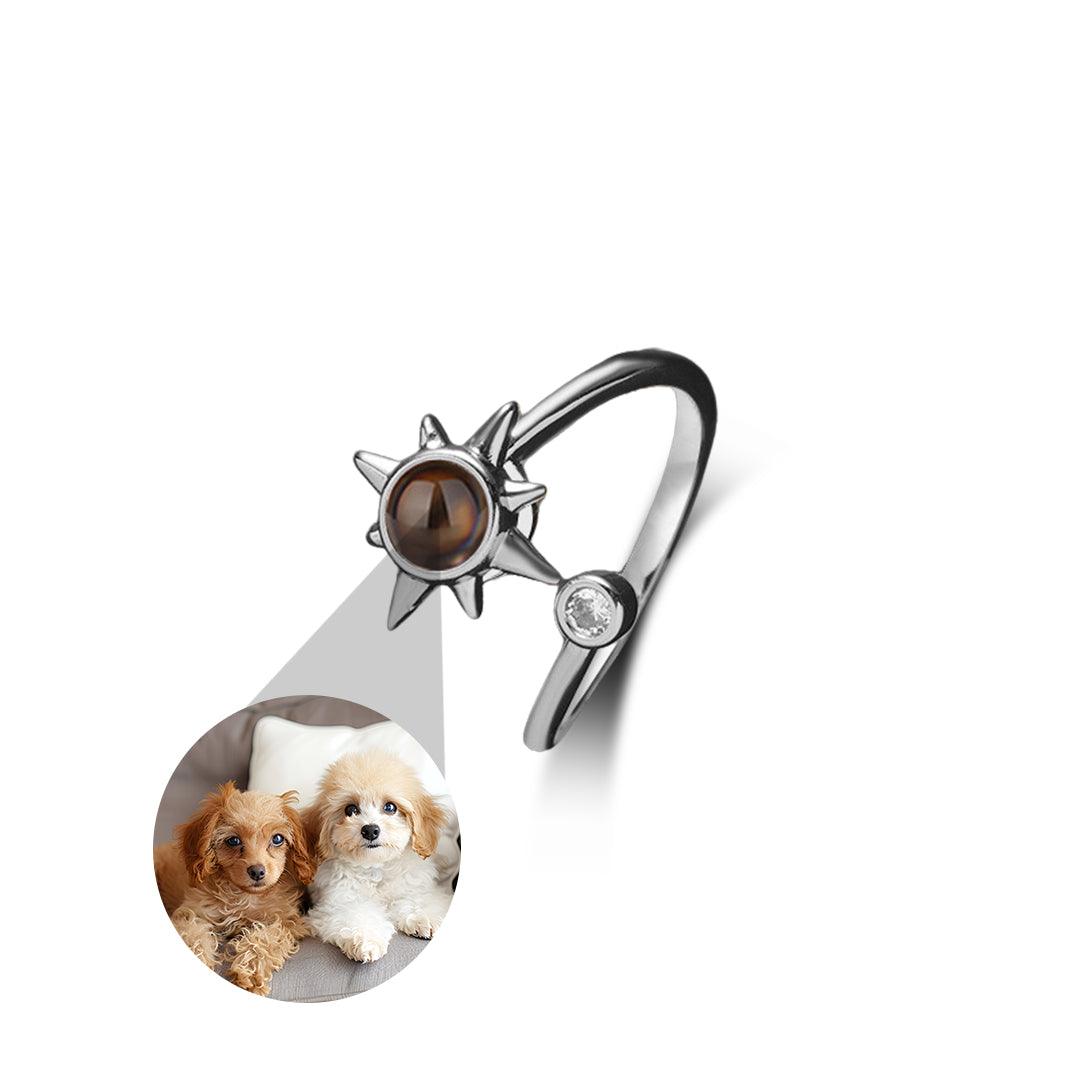 Silver ring with a sun design featuring two dogs inside a circular cutout on a white background