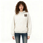A white hoodie featuring a finely embroidered design on a white background.
