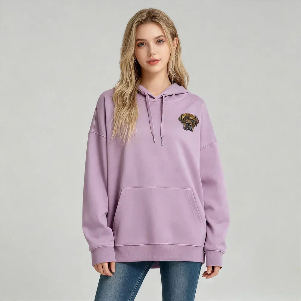 Woman wearing a hoodie with a dog graphic on a plain background