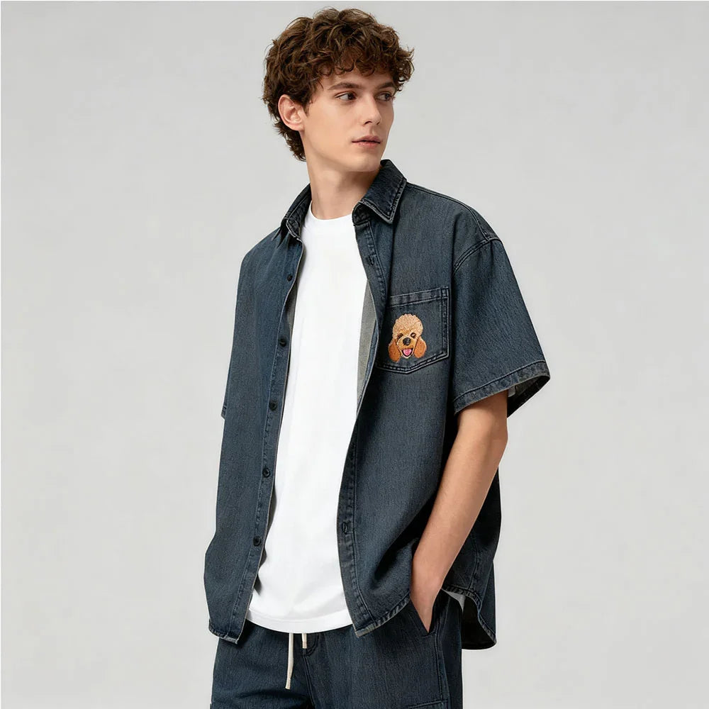 Man wearing a denim shirt with a teddy bear patch on a plain background