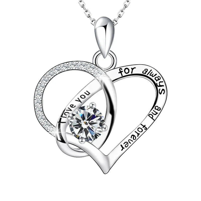 Silver heart-shaped pendant with 'I love you' and 'for always and forever' engraving on a white background
