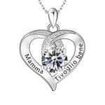 Silver heart-shaped pendant with a central gemstone and engraved text on a white background