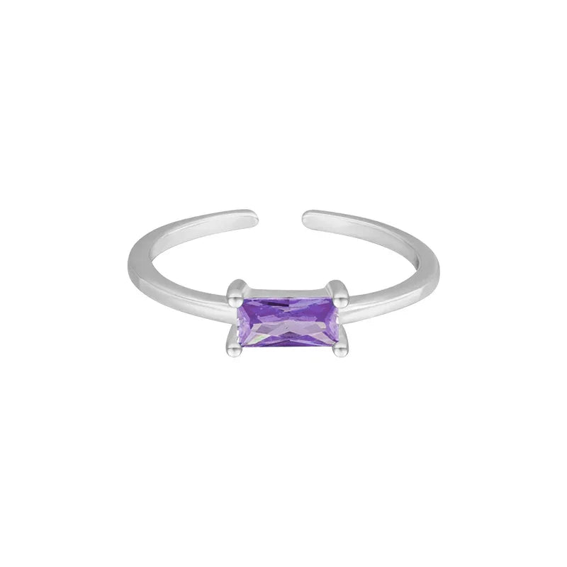 Silver ring with a purple gemstone on a white background