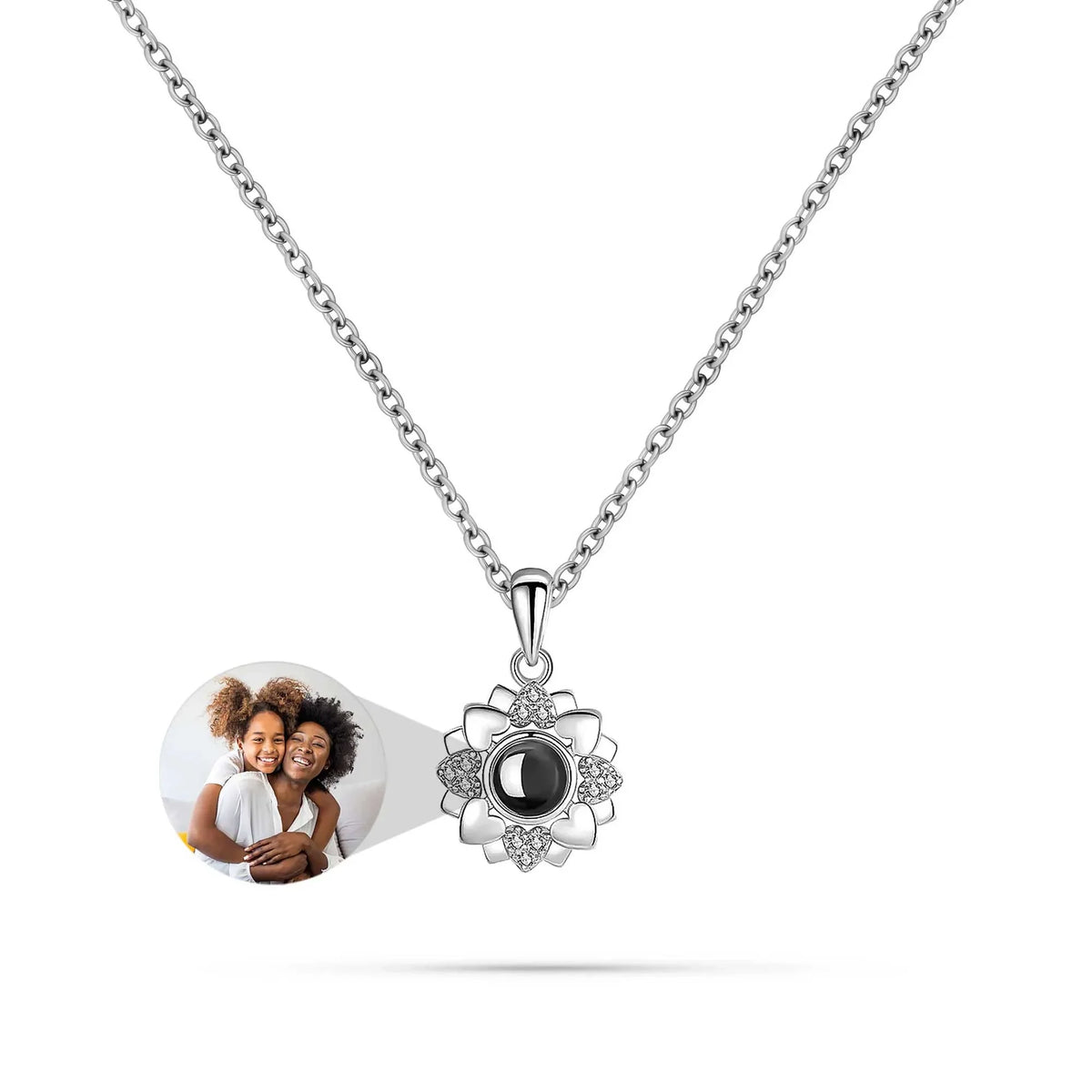 Necklace with a photo charm and a pendant featuring a moon design on a white background