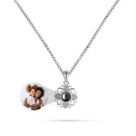 Necklace with a photo charm and a pendant featuring a moon design on a white background