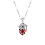 Silver necklace with a graduation cap pendant featuring a red heart-shaped gemstone and a personalized name engraving.