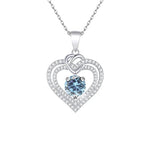 Heart-shaped pendant with a blue gemstone on a white background