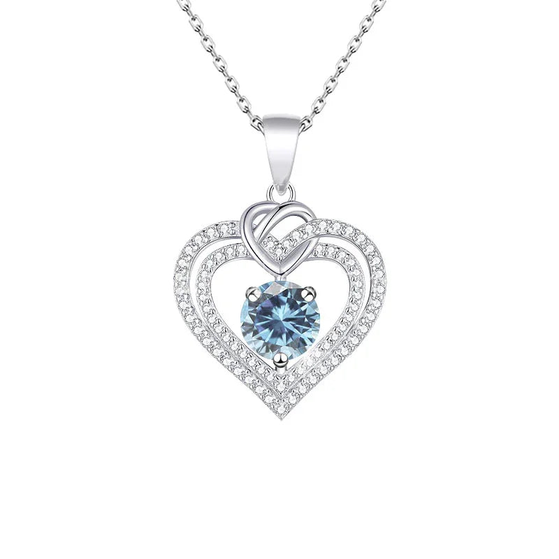 Heart-shaped pendant with a blue gemstone on a white background