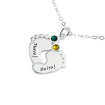 Silver baby feet necklace with two birthstones and engraved names.
