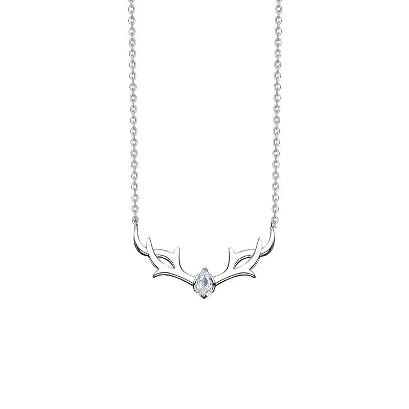A delicate silver necklace featuring an elegant antler design with a single teardrop-shaped gemstone at the center, symbolizing winter charm and festive elegance.
