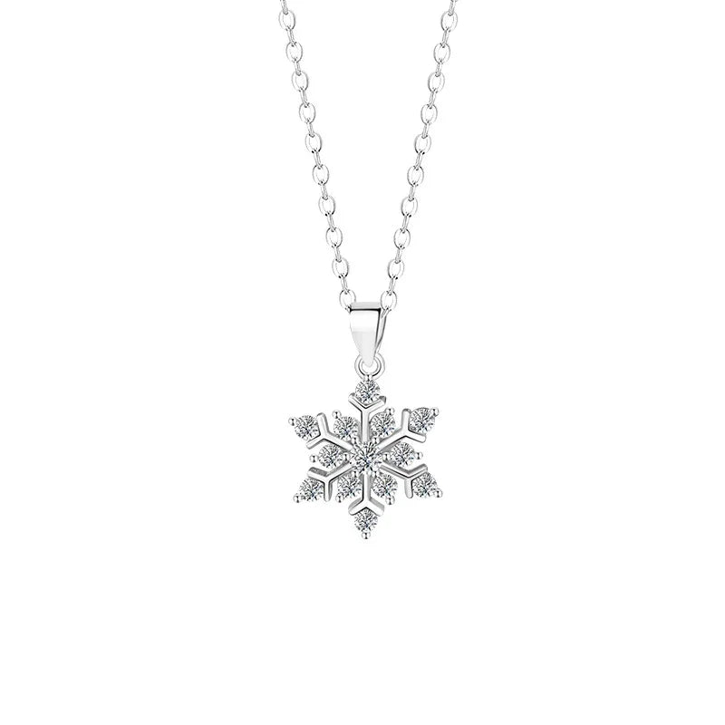 Silver necklace with a delicate snowflake pendant adorned with sparkling zircon stones on a white background.