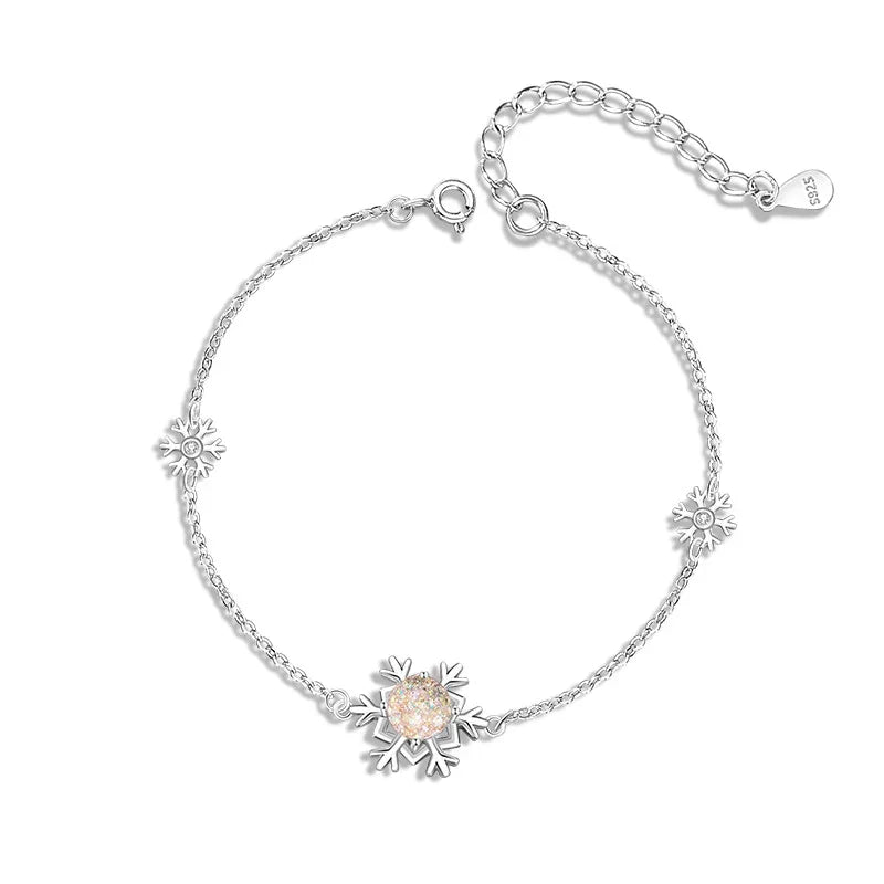 Elegant silver bracelet featuring three snowflake charms.The center snowflake is adorned with a sparkling zircon stone.
