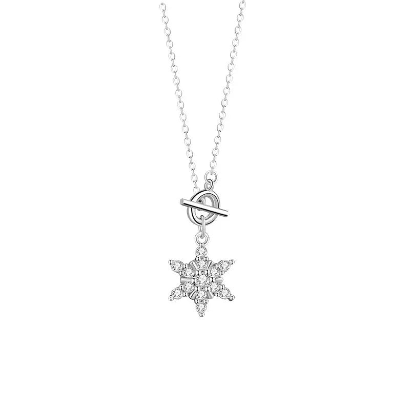 Silver necklace with a sparkling snowflake star pendant and a toggle clasp on a white background.