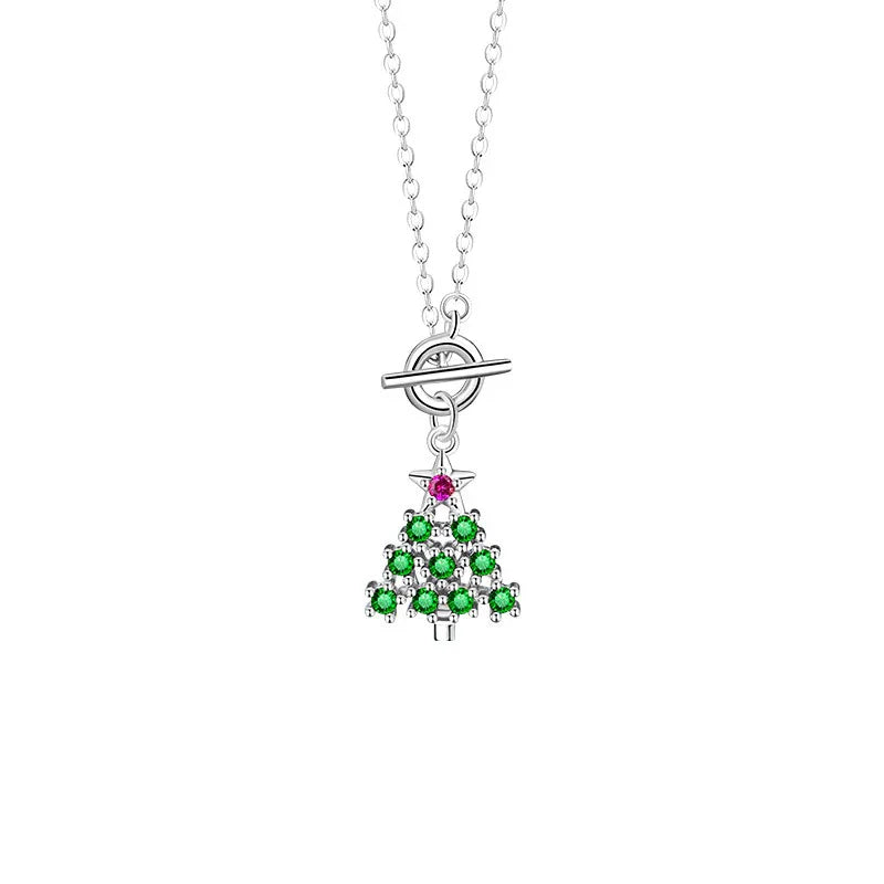 A delicate silver necklace featuring a Christmas tree pendant adorned with green zircon stones and a small pink star accent, symbolizing festive holiday charm.