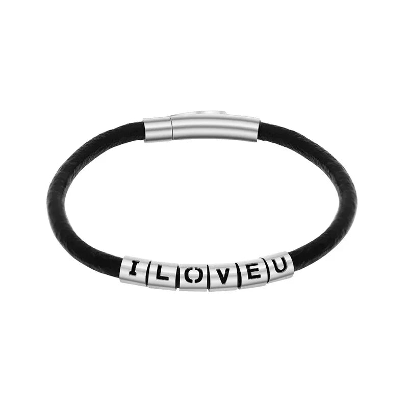 A men’s bracelet with a black leather strap and silver square beads spelling out a short message. It features a sleek metallic magnetic clasp for a clean, modern look.