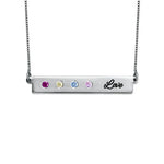 Silver bar necklace with four colorful birthstones and the word “Love” engraved on the right side.