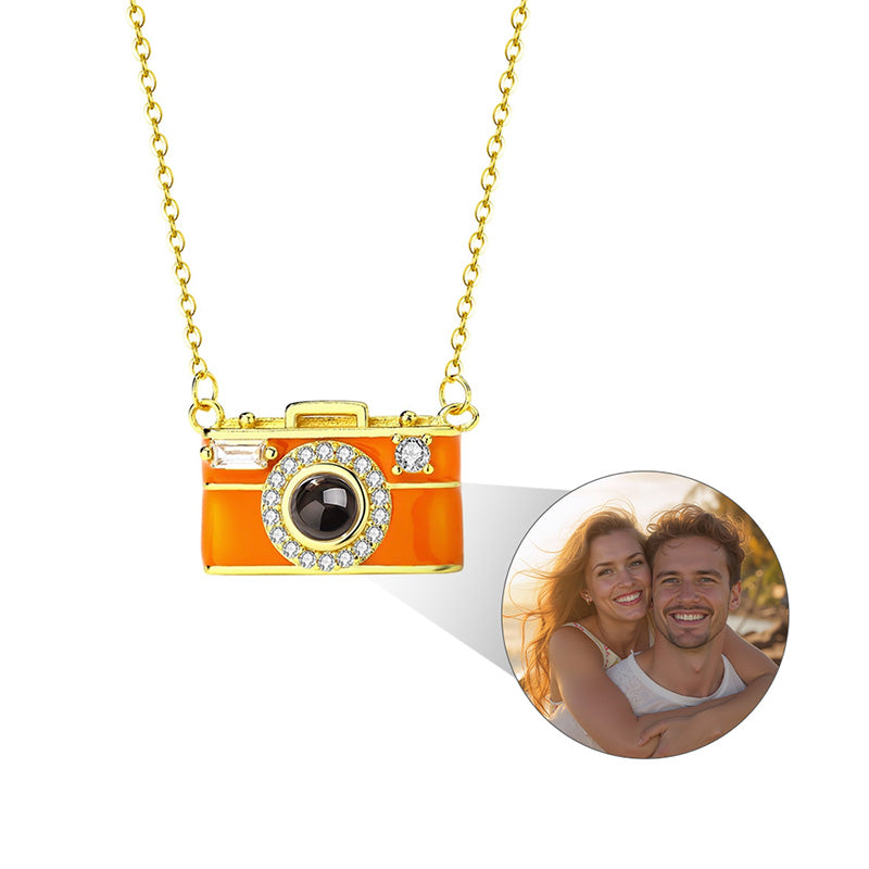 Camera-shaped pendant necklace with a photo of a couple on a white background