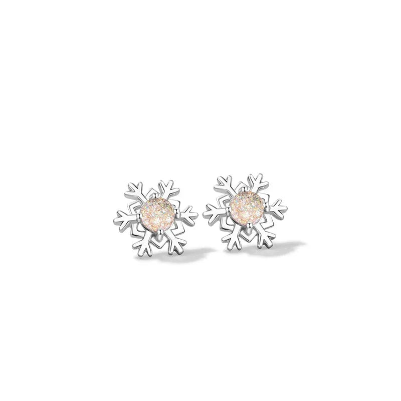 A pair of elegant silver snowflake stud earrings with round, shimmering glaze stone centers, displayed on a clean white background.