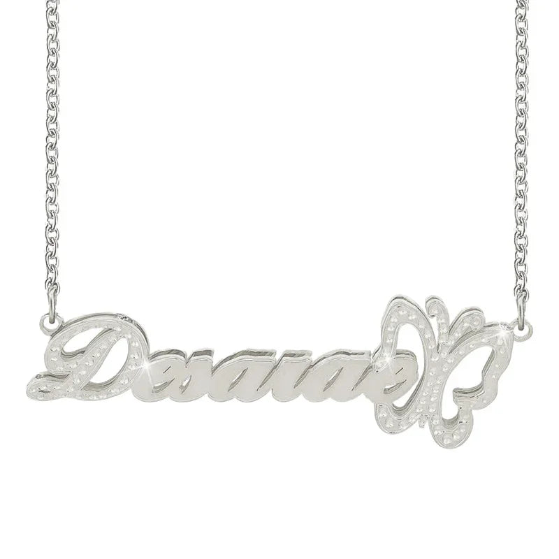 A personalized silver name necklace featuring the word “Desanae” in elegant cursive script, adorned with a delicate butterfly outline embellished with small decorative details on the right side.