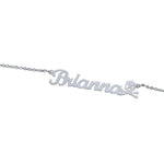 A personalized silver necklace featuring the name “Brianna” in elegant cursive script, accented with a small skull and crossbones charm at the end for a bold and stylish look.