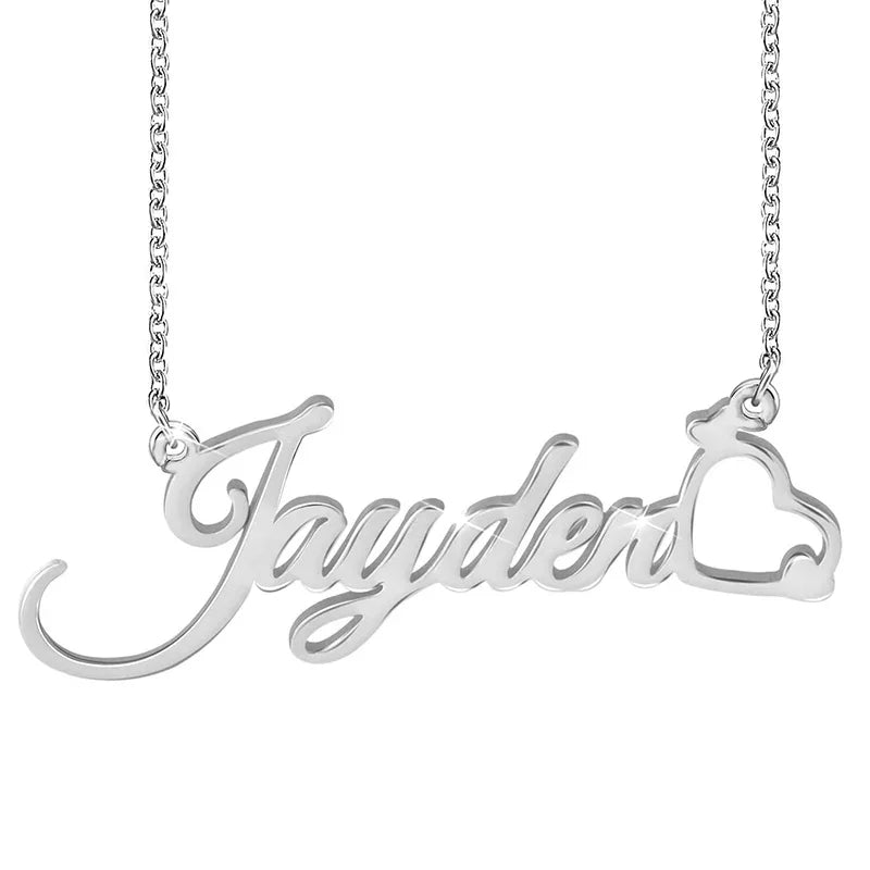 A silver name necklace featuring the word “Jayden” in elegant cursive font, with a small open heart design integrated at the end of the name, attached to a fine chain.