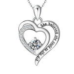 Empowered Heart Birthstone Necklace featuring double-heart design, engraved with “She believed she could, so she did,” and adorned with a radiant heart-shaped birthstone in sterling silver.