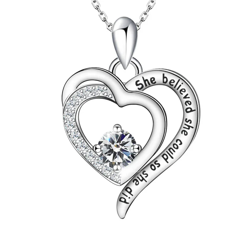 Empowered Heart Birthstone Necklace featuring double-heart design, engraved with “She believed she could, so she did,” and adorned with a radiant heart-shaped birthstone in sterling silver.