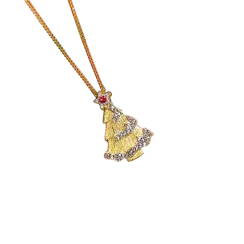 A Christmas tree pendant necklace with a gold-tone finish and intricate detailing. The pendant features a red gemstone star at the top and sparkling white accents outlining the tree shape. It hangs from a fine gold chain, creating a festive and elegant look.