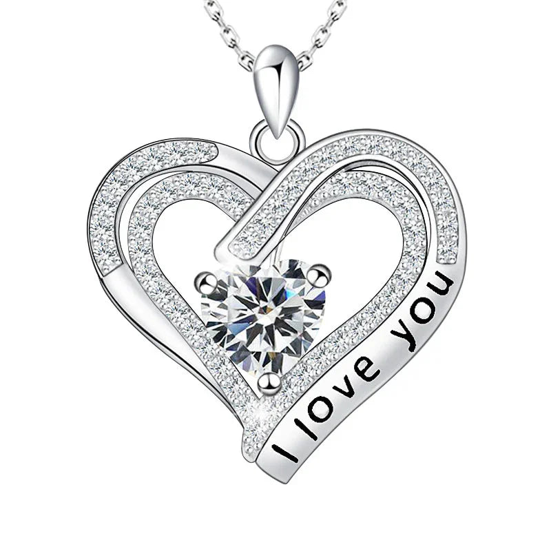 Heart-shaped silver pendant with 'I LOVE YOU' engraving on a white background
