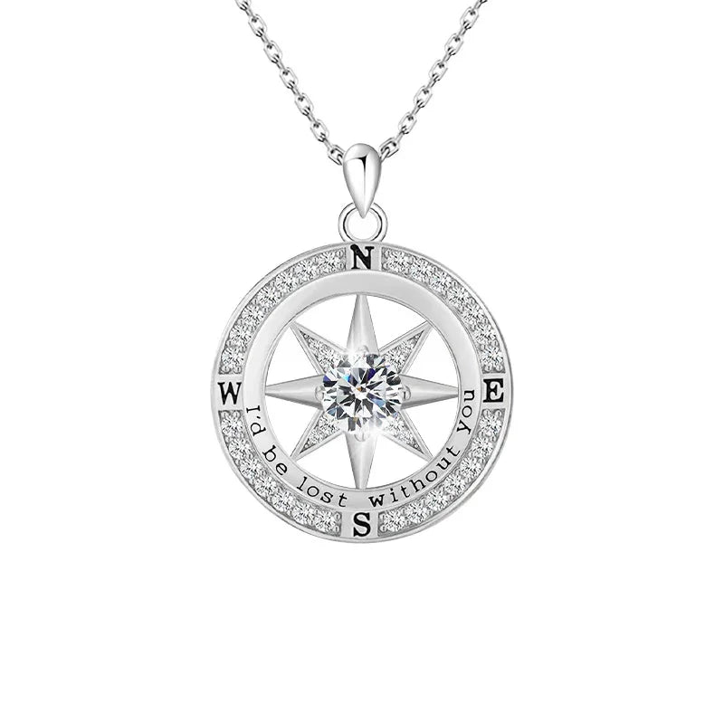 Silver compass-shaped pendant featuring a central round gemstone, engraved with the text “I’d be lost without you” around the outer ring, displayed on a white background.