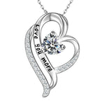 Silver heart-shaped necklace engraved with “Love you more,” featuring a sparkling heart-cut birthstone at the center.
