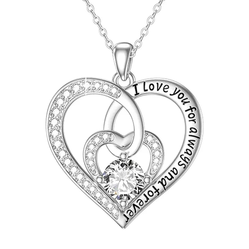 Silver triple-heart pendant featuring a central round gemstone and engraved text that reads “I love you for always and forever,” displayed on a white background.