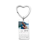 Heart-shaped keychain with a calendar and photo on a white background