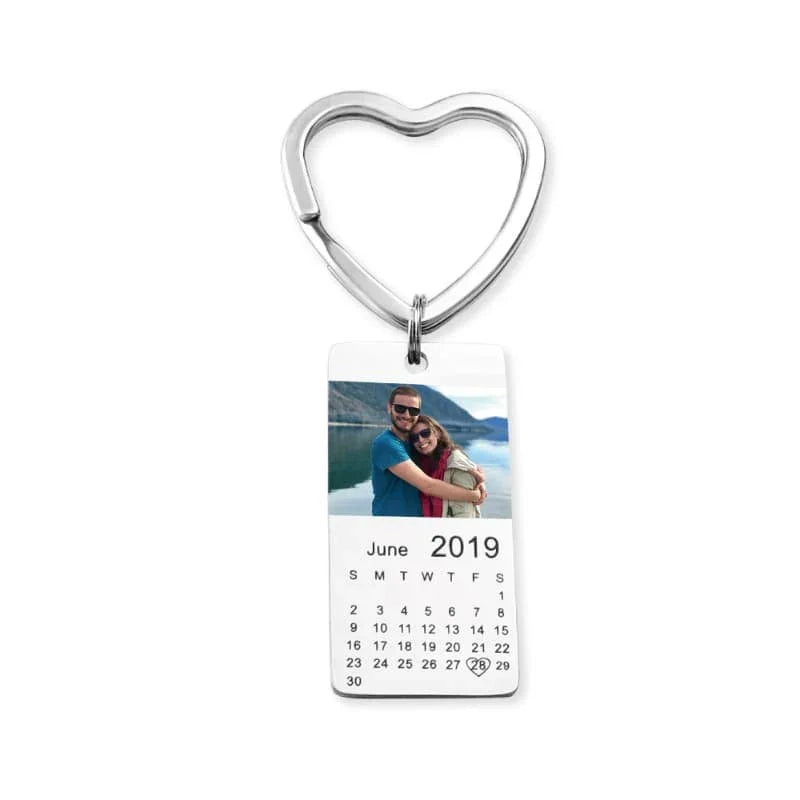 Heart-shaped keychain with a calendar and photo on a white background