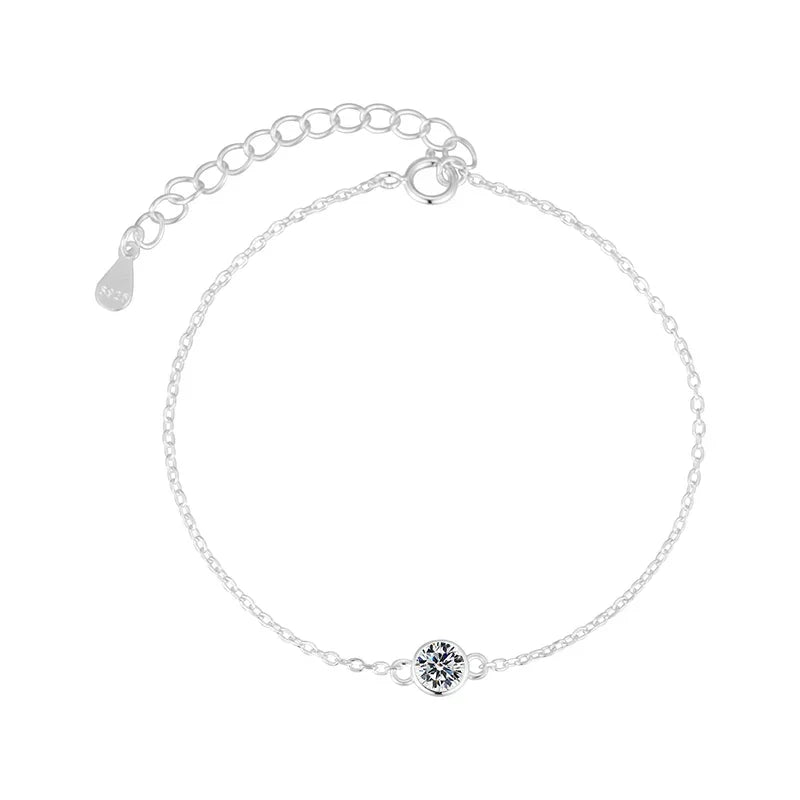 Silver bracelet with a small round clasp on a white background