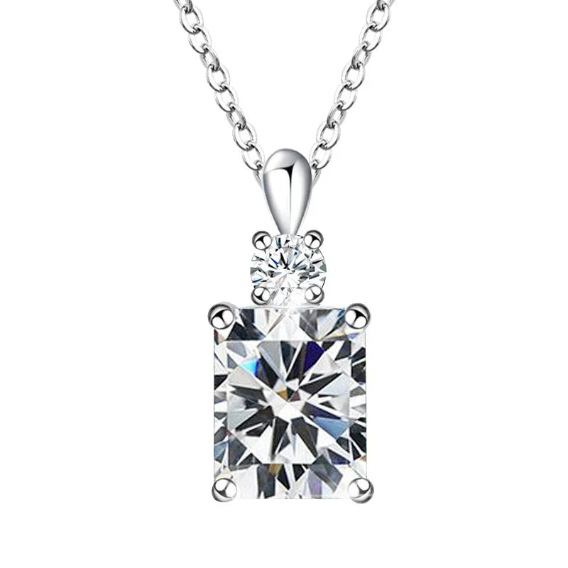 A silver necklace featuring a round crystal above a radiant rectangular birthstone, symbolizing timeless grace and elegant simplicity.