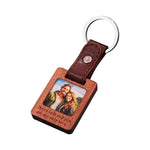 Keychain with wooden plaque and leather strap featuring a photo of a couple and text.