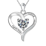 Silver heart-shaped birthstone necklace engraved with “Faith Hope Love,” featuring a central sparkling stone symbolizing belief, hope, and love.