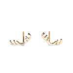A pair of delicate gold stud earrings shaped like reindeer antlers, designed with smooth curves for a festive and elegant holiday look.