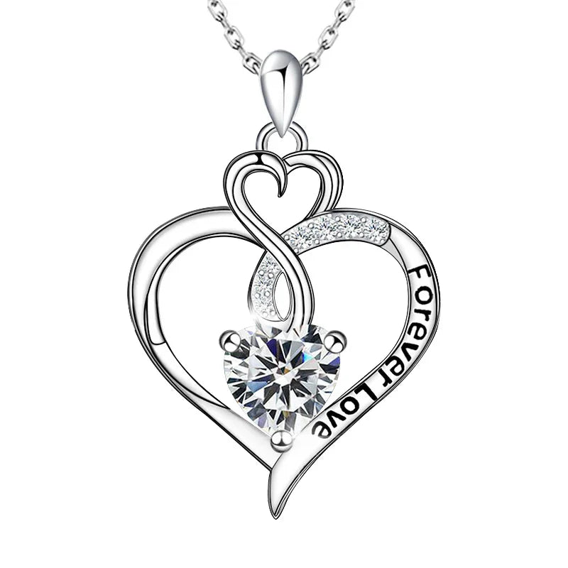 Forever Grace Birthstone Necklace featuring a double heart design engraved with “Forever Love,” adorned with a radiant heart-shaped birthstone in sterling silver.