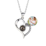 Heart-shaped silver necklace with a photo pendant on a white background