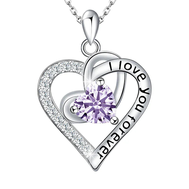 Silver heart-shaped pendant with 'I love you forever' engraving and purple gemstone on a white background