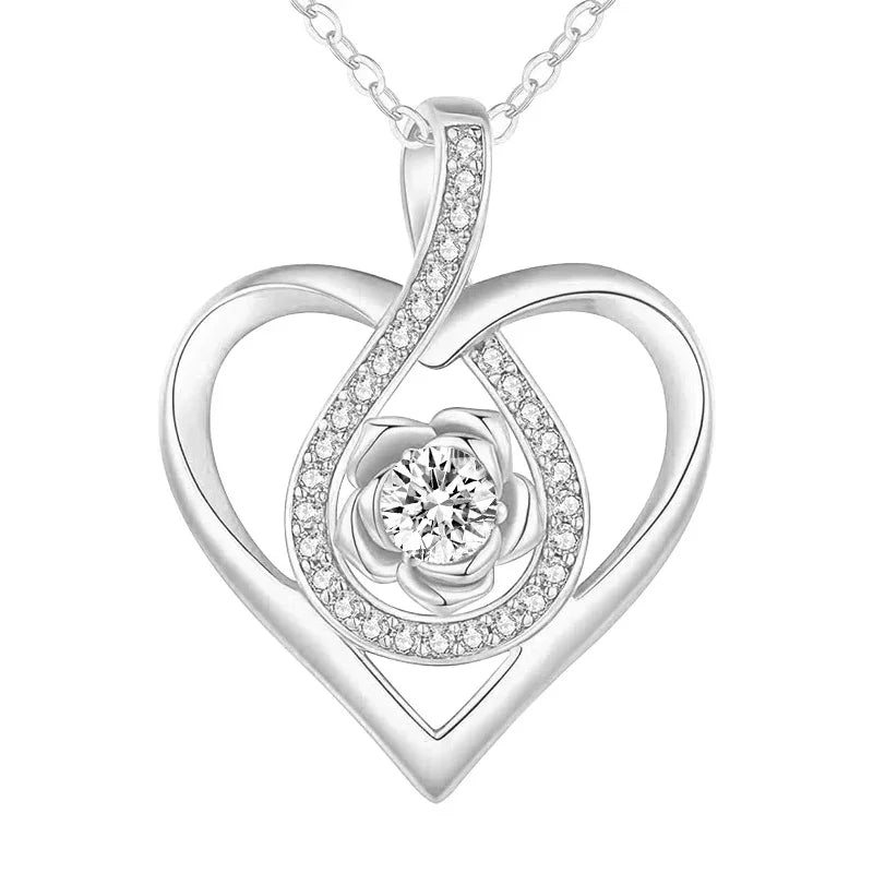 Silver double-heart pendant featuring a central flower-shaped gemstone surrounded by sparkling crystals, displayed on a white background.