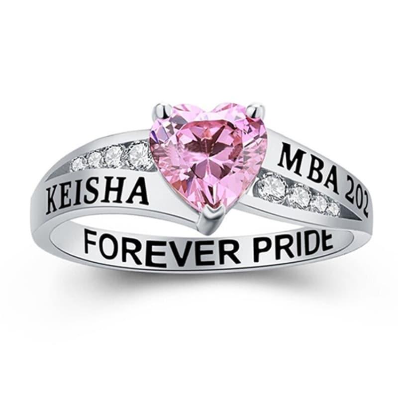 Silver ring with a pink heart-shaped gemstone and engraved text on the band.