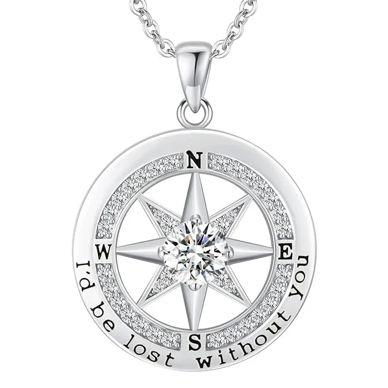 Silver compass necklace with diamond in the center on a white background