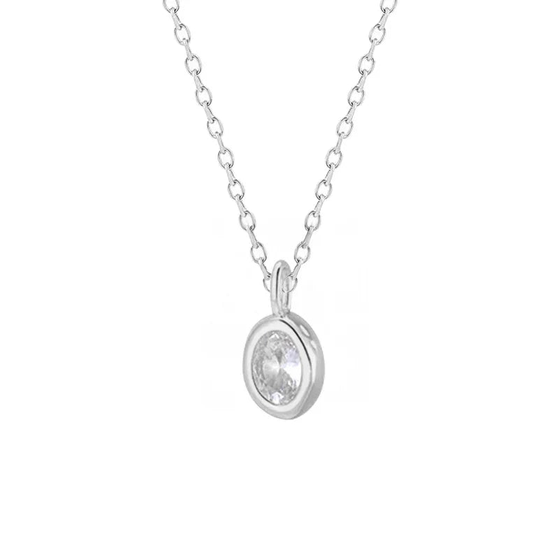 Silver necklace with a round pendant on a white background