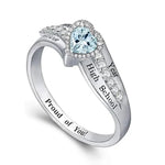 Silver ring with a light blue heart-shaped stone and engraved graduation-style text.