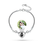 Bracelet with a heart-shaped photo frame featuring a couple, on a white background
