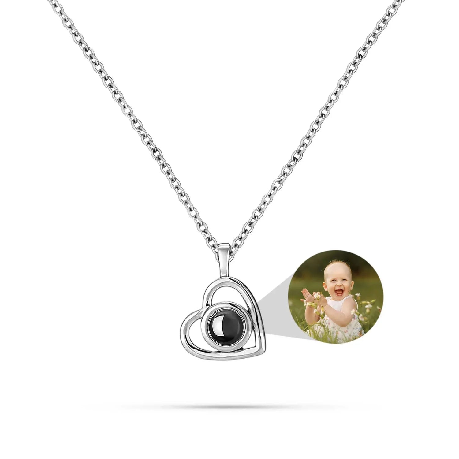 Heart-shaped pendant with a photo of a baby on a white background