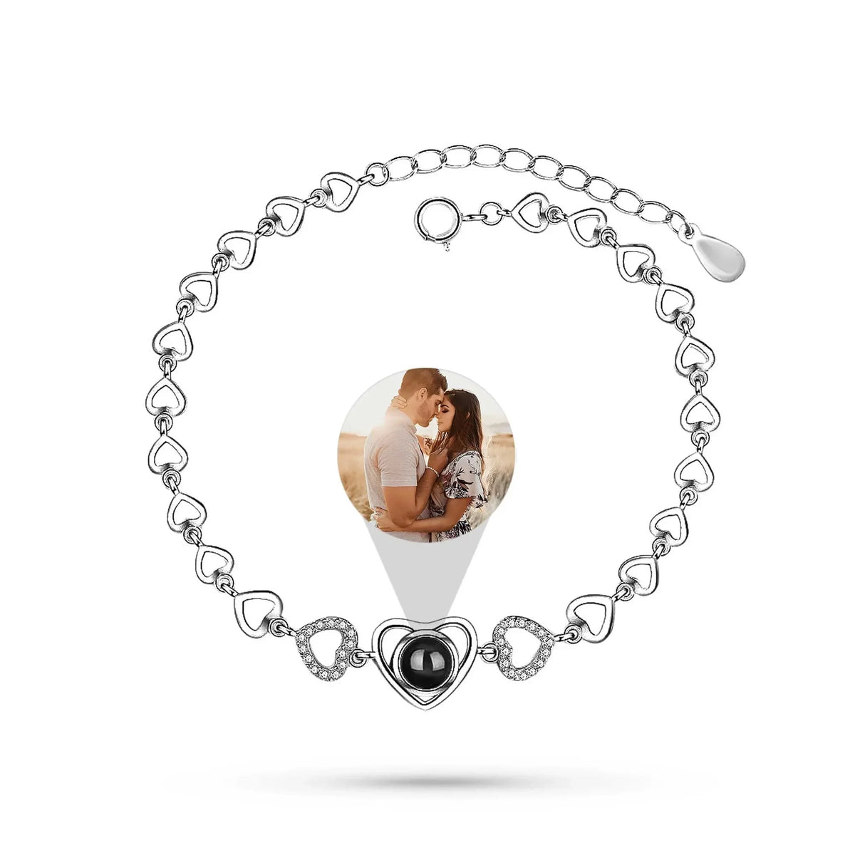 Silver bracelet with heart-shaped charm featuring a photo of a couple on a white background